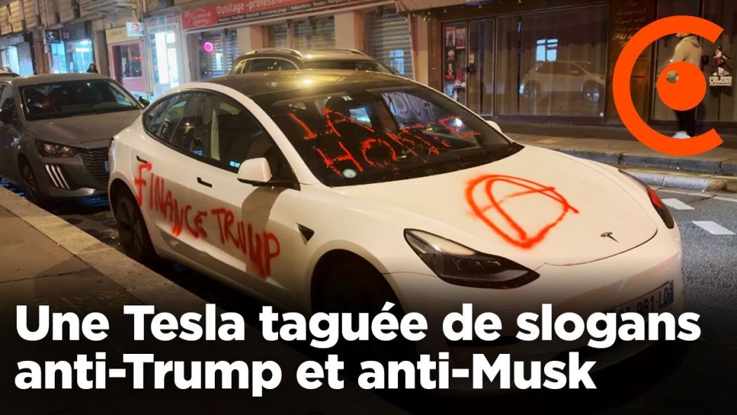 A Tesla tagged with anti-Trump and anti-Musk slogans