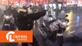Yellow Vests Act 6: a policeman on a motorcycle pulls out his gun